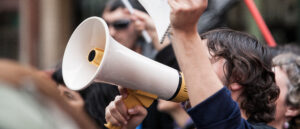 demostrator with megaphone and notebook protesting